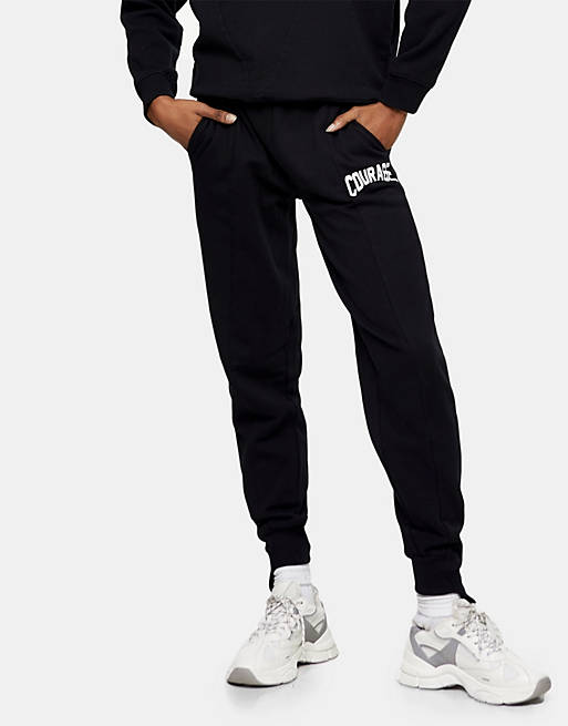 Topshop oversized cuffed jogger with collegic courage leg graphic in black