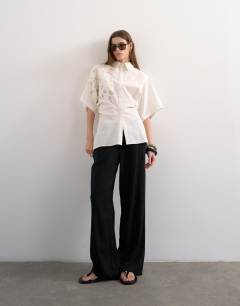Model wearing Oversized cutwork short sleeve shirt in white