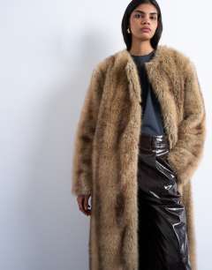 Model wearing Oversized faux fur collarless long coat in natural stripe in beige