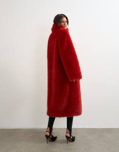 Model wearing Oversized faux fur longline coat in red