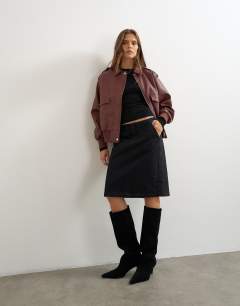 Model wearing Oversized faux leather bomber jacket in burgundy