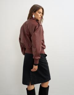 Model wearing Oversized faux leather bomber jacket in burgundy