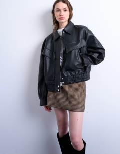 Model wearing Oversized faux leather bubble boxy zip through bomber jacket in black
