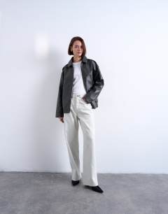 Model wearing Oversized faux leather bubble vintage wash seam detail zip thru bomber jacket in washed black