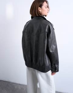 Model wearing Oversized faux leather bubble vintage wash seam detail zip thru bomber jacket in washed black