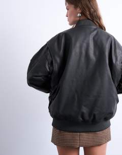 Model wearing Oversized faux leather washed MA1 bomber jacket in washed black