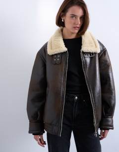 Model wearing Oversized funnel tab detail shearling bomber in brown
