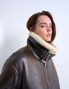 Model wearing Oversized funnel tab detail shearling bomber in brown