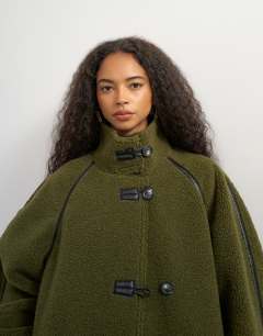 Model wearing Oversized longline borg coat in green