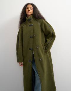 Model wearing Oversized longline borg coat in green