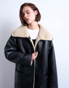 Model wearing Oversized longline coat in black and cream