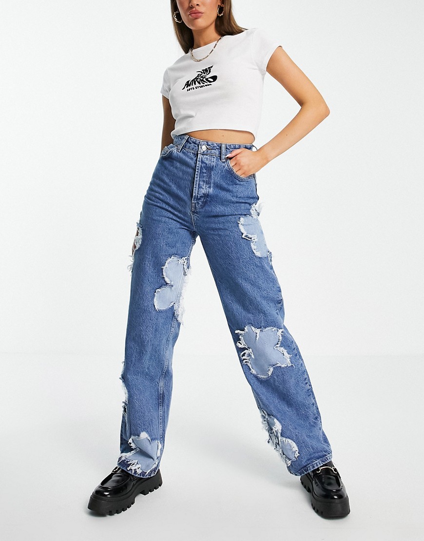 Topshop oversized Mom jean with flower patches in mid blue