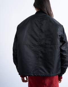 Model wearing Oversized nylon bomber jacket in black