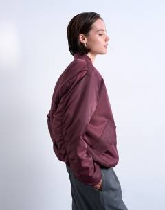 Model wearing Oversized nylon bomber jacket in burgundy