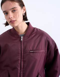 Model wearing Oversized nylon bomber jacket in burgundy