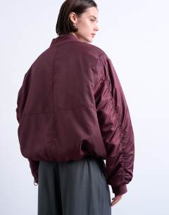 Model wearing Oversized nylon bomber jacket in burgundy