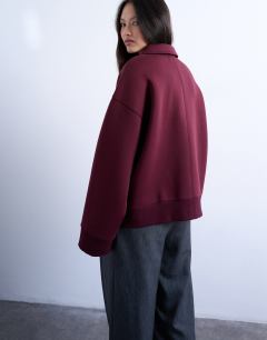 Model wearing Oversized scuba-style fabric zip through jacket in burgundy