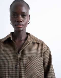 Model wearing Oversized shirt in heritage check