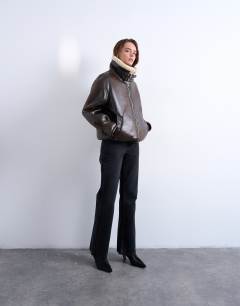 Model wearing Oversized tab detail shearling bomber in brown