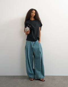 Model wearing Oversized tank circle tee in black