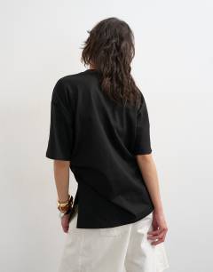 Model wearing Oversized tee with knot hem in black