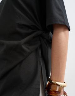Model wearing Oversized tee with knot hem in black