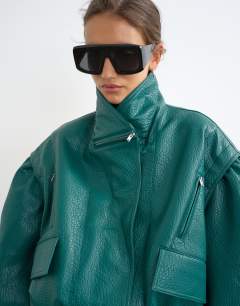 Model wearing Overszied faux leather cropped bomber with zips in green