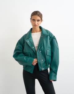 Model wearing Overszied faux leather cropped bomber with zips in green