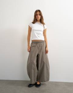 Model wearing Ovoid mid length trouser in blue check