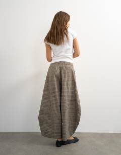 Model wearing Ovoid mid length trouser in blue check
