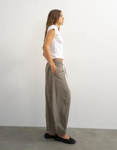 Model wearing Ovoid mid length trouser in blue check
