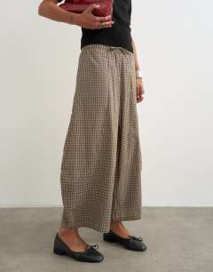 Model wearing Ovoid mid length trouser in brown check