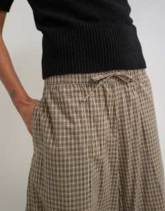 Model wearing Ovoid mid length trouser in brown check