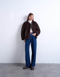 Model wearing Ovoid short shearling double breasted jacket in cream