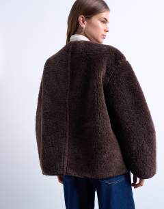 Model wearing Ovoid short shearling double breasted jacket in cream