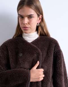 Model wearing Ovoid short shearling double breasted jacket in cream