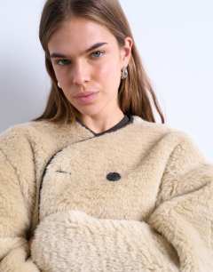 Model wearing Ovoid short shearling double breasted jacket in cream