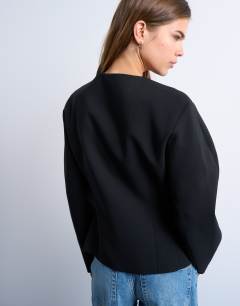 Model wearing Ovoid sleeve blazer top in black