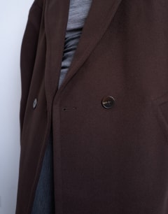 Model wearing Ovoid sleeve double breasted longline formal coat in chocolate