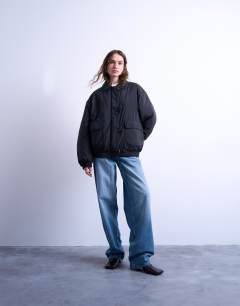 Model wearing Padded hybrid toggle bomber in black