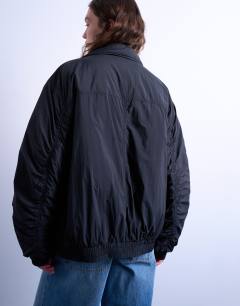 Model wearing Padded hybrid toggle bomber in black