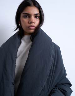 Model wearing Padded shawl puffer jacket in washed black