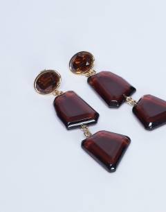 Model wearing Paige abstract drop earrings in burgundy