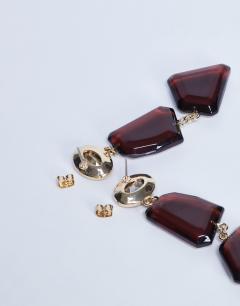 Model wearing Paige abstract drop earrings in burgundy