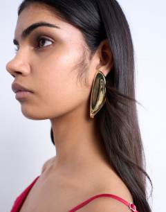 Model wearing Paloma statement earring in gold