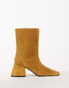 Model wearing Pamela real suede block heel ankle boot in tan