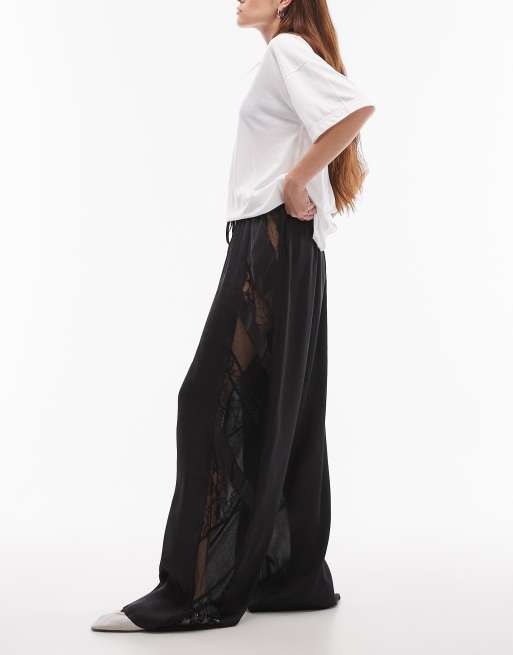 Topshop - Pantaloni a fondo ampio in raso color nero con motivo patchwork in pizzo e tessuto stropicciato
