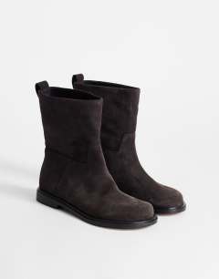 Model wearing Pascal  real leather suede ankle boot in chocolate