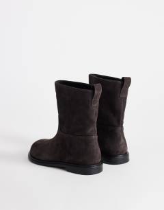 Model wearing Pascal  real leather suede ankle boot in chocolate