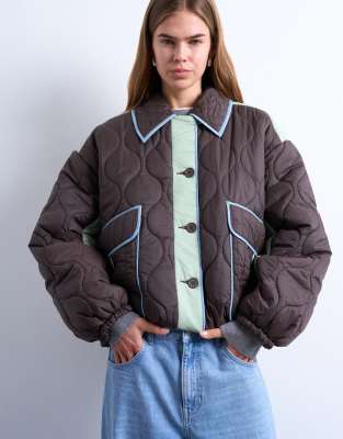 Patchwork quilted shacket with contrast piping in blue